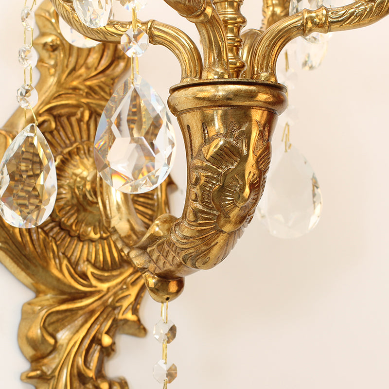 The art decorative wall light emitting a soft glow, highlighting its elegant proportions and crystal brilliance.