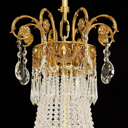 Extreme close-up of intricate brass scrollwork and cascading crystal bead strings.