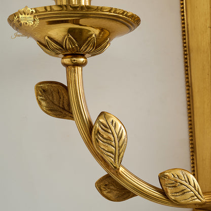 Macro detail of the engraved brass candle cup and leaf arm of the George III Girandole sconce by Jewellery Top.
