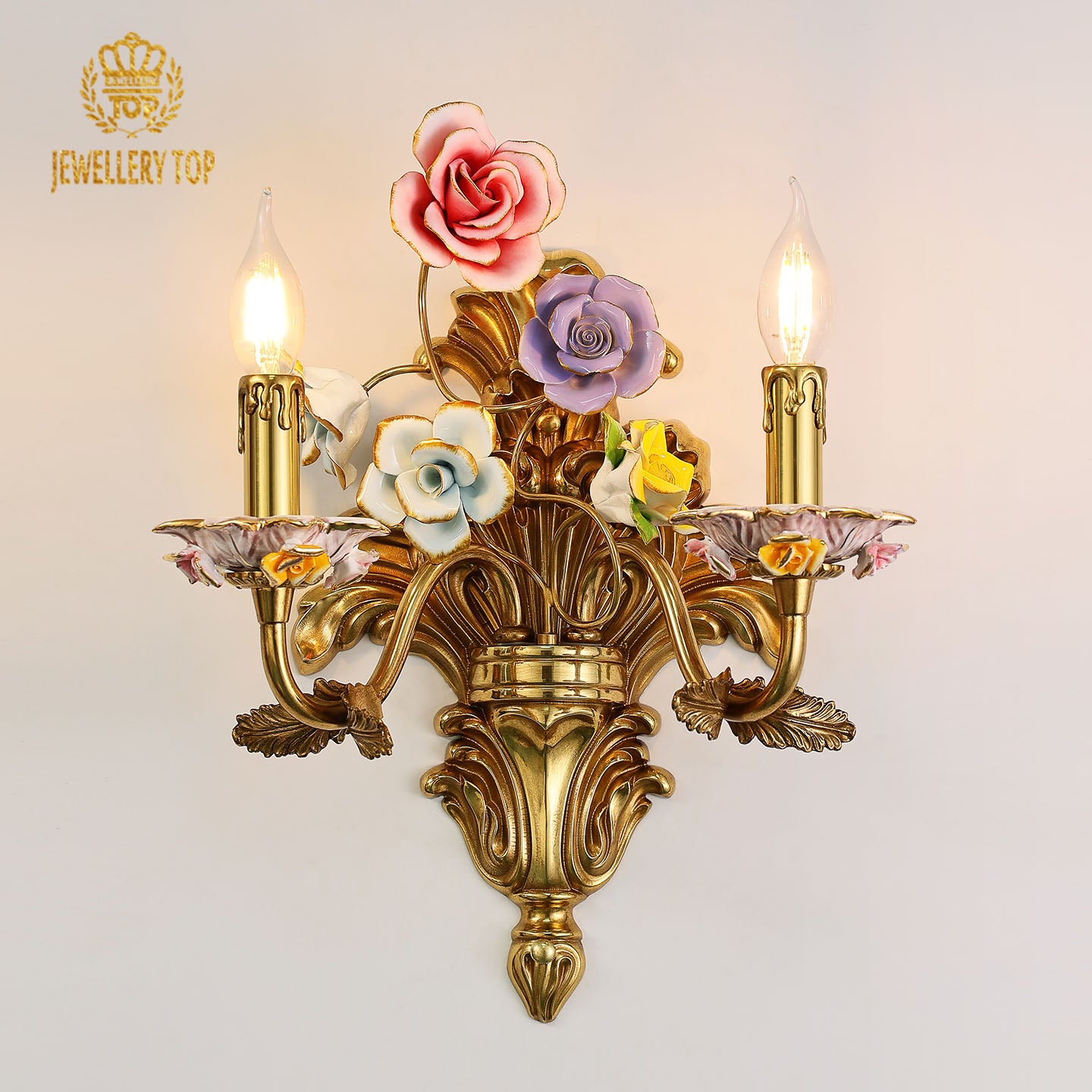 JEWELLERY TOP Jardin de Porcelaine brass wall lamp with colorful ceramic flowers and two candle lights on a white wall.