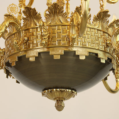 Detailed macro shot of ornate brass engraving and woven texture on the chandelier's sphere.