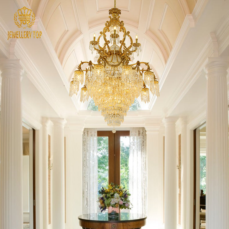 Hotel lobby scene featuring the majestic crystal and brass chandelier in a vaulted space.