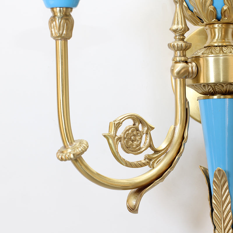 Focus on the intricate brass scrollwork and brushed metal texture of the lamp's arm and base.