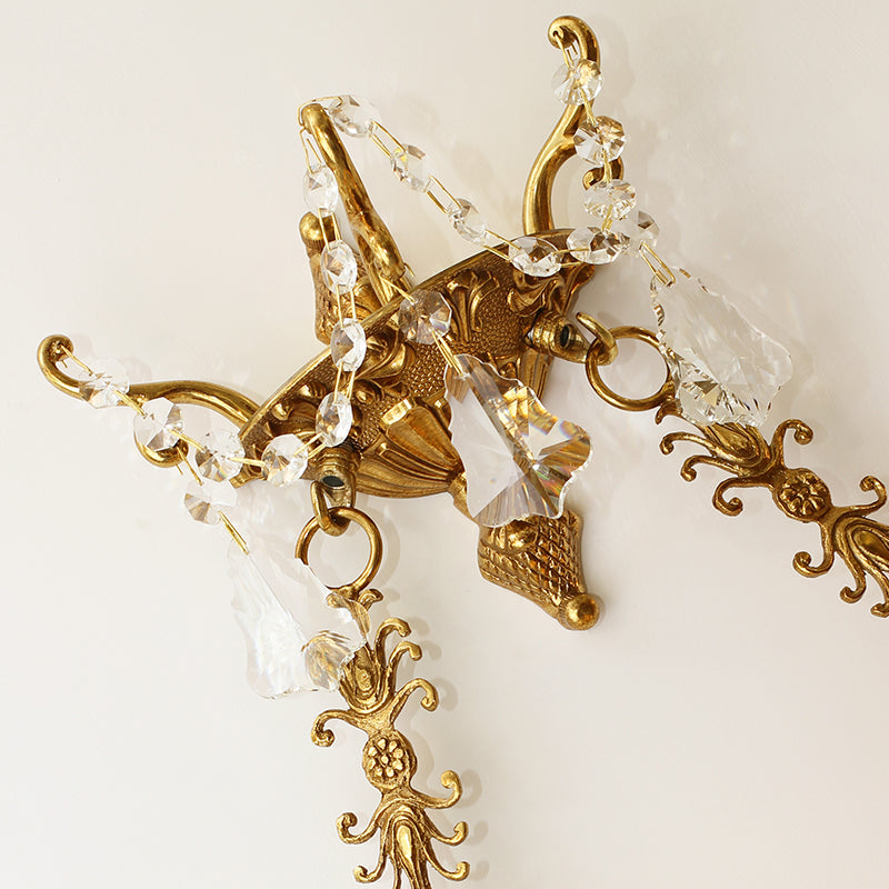 Side profile view of the sconce highlighting the depth of the crystal cascade and the upward-curving design.