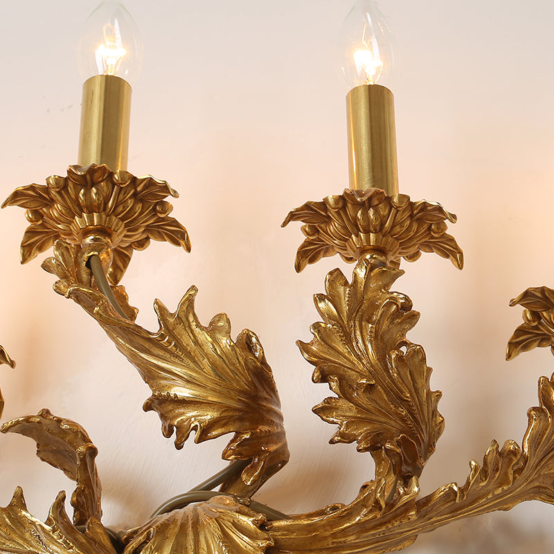 Detailed shot of the wall lamp’s curved arm, candle-style bulbs, and exquisite metal craftsmanship.