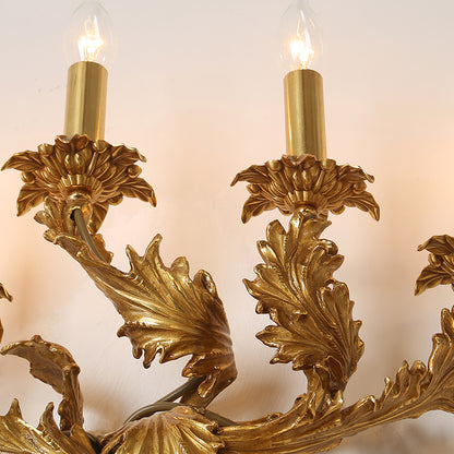 Detailed shot of the wall lamp’s curved arm, candle-style bulbs, and exquisite metal craftsmanship.