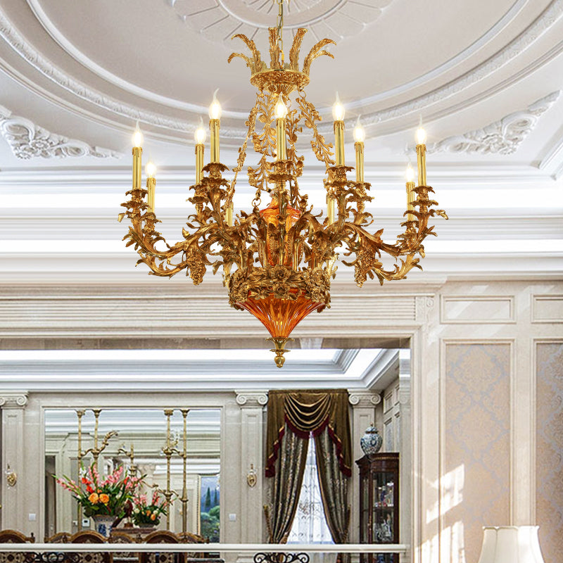 The brass chandelier installed in an elegant room with a decorative white ceiling and wainscoting.