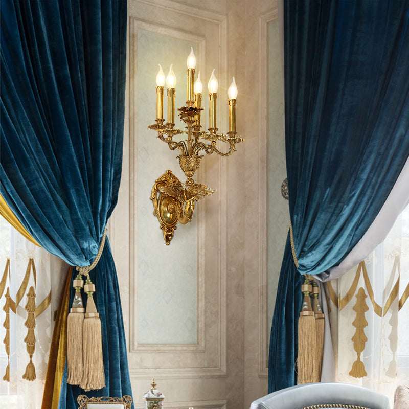 The Victorian-style wall lamp installed between deep blue velvet curtains in an elegant, classically decorated room.