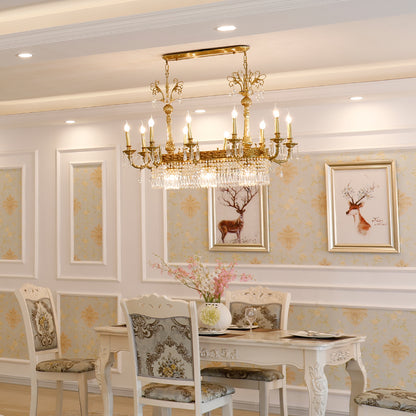 JEWELLERY TOP brass chandelier above a set dining table with ornate chairs and artwork.