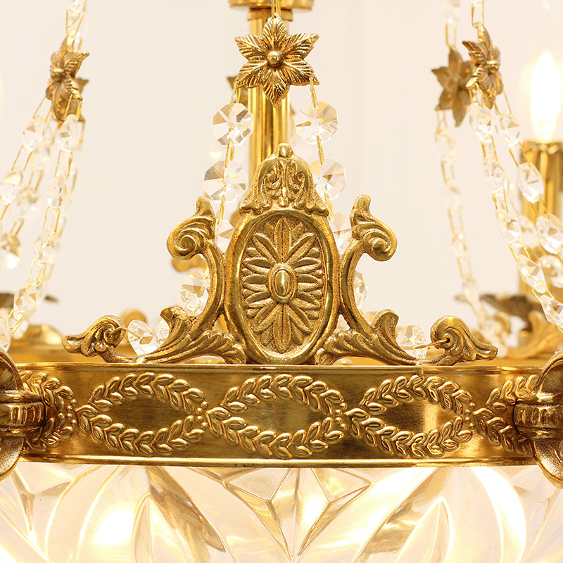 Macro shot of an ornate brass sunburst medallion and rope on the chandelier's canopy.