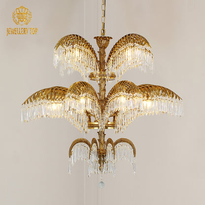 Wide angle view of the luxury chandelier illuminating an ornate ceiling with classical frescoes and gold trim.