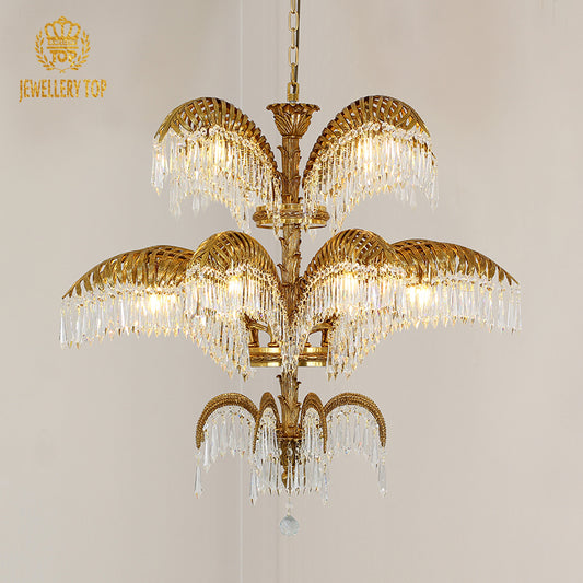 Wide angle view of the luxury chandelier illuminating an ornate ceiling with classical frescoes and gold trim.