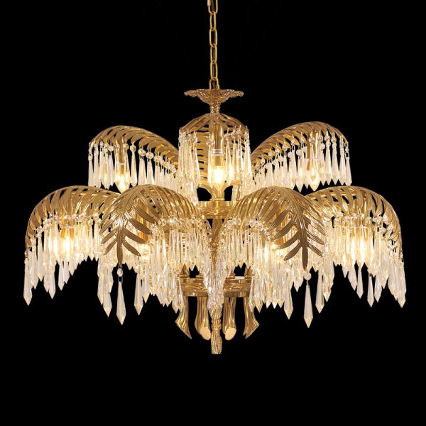 Close-up detail of the ornate brass palm leaf structure and hanging crystal strings.