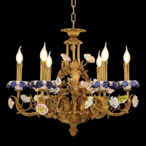 French brass chandelier with multi-colored porcelain blossoms and candle bulbs, black background.