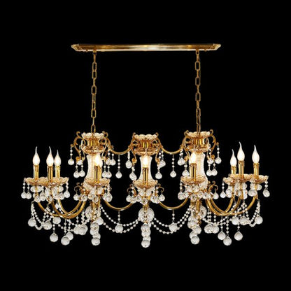 Full view of the French Baroque Grande Crystal Cascade brass chandelier glowing against a stark black background.
