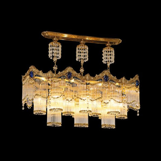 Full studio shot of the French Baroque style sapphire gem cascading crystal brass chandelier glowing against a stark black background.