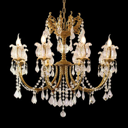 Close-up of a French brass chandelier’s dense crystal fringe and candle-style bulbs on black.