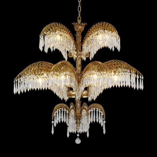 Full studio shot of the French Victorian palm leaves solid brass chandelier glowing against a stark black background.