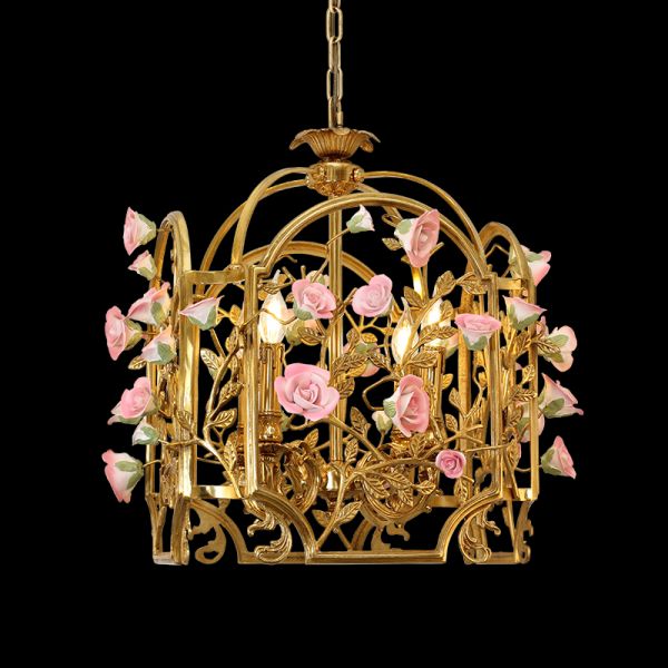 Full view of the French Rose Garden cage brass chandelier adorned with cascading pink porcelain roses on a black background.