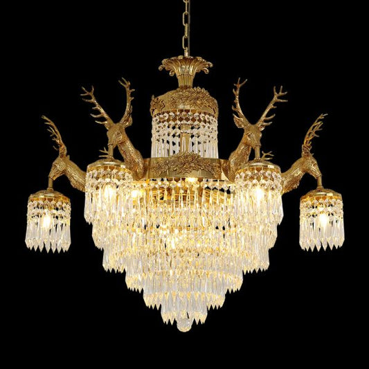 Full studio shot of the French Baroque deer head solid brass crystal chandelier glowing against a stark black background.