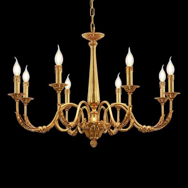Lit luxury brass chandelier as a living room centerpiece, casting a warm glow.