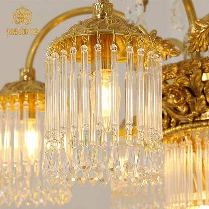 Close-up front view of the laurel wreath brass chandelier with cascading crystal drops.