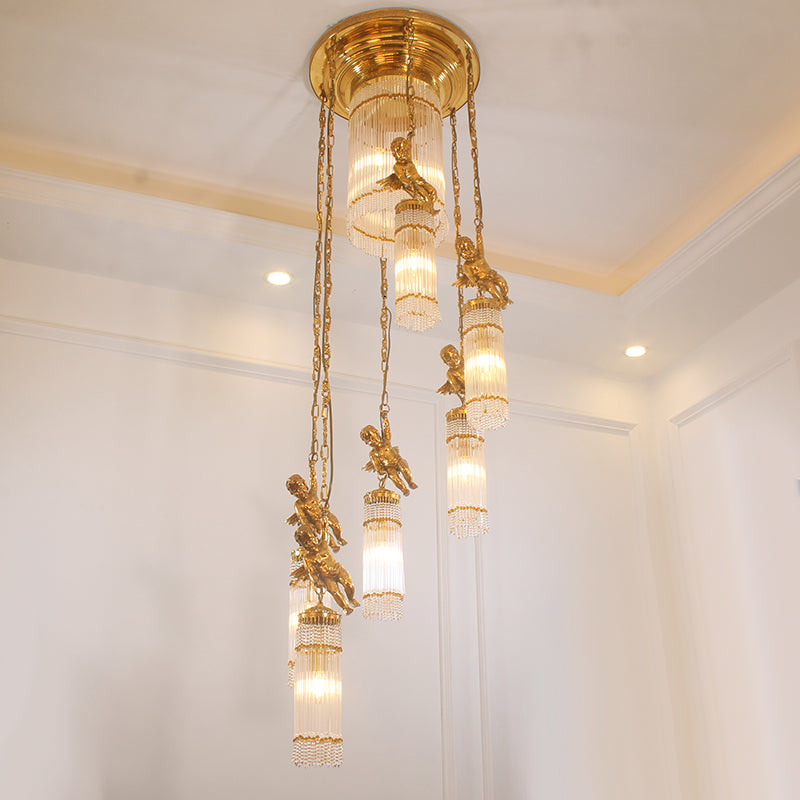 The French classical brass chandelier installed on a staircase, showing its vertical elegance.