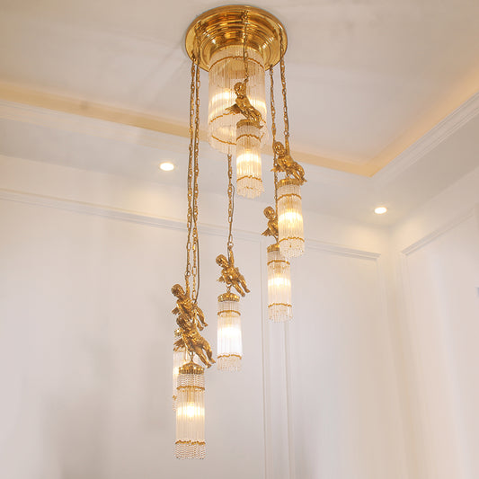 The French classical brass chandelier installed on a staircase, showing its vertical elegance.