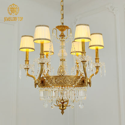 JEWELLERY TOP brand's french chandelier showcasing ornate golden arms and fringed fabric lampshades.