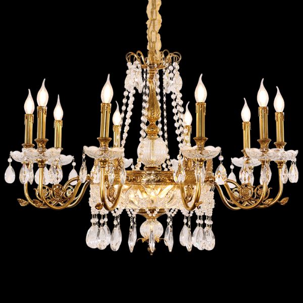 Close-up front view of a Baroque brass chandelier with flower crystal centerpiece on black.