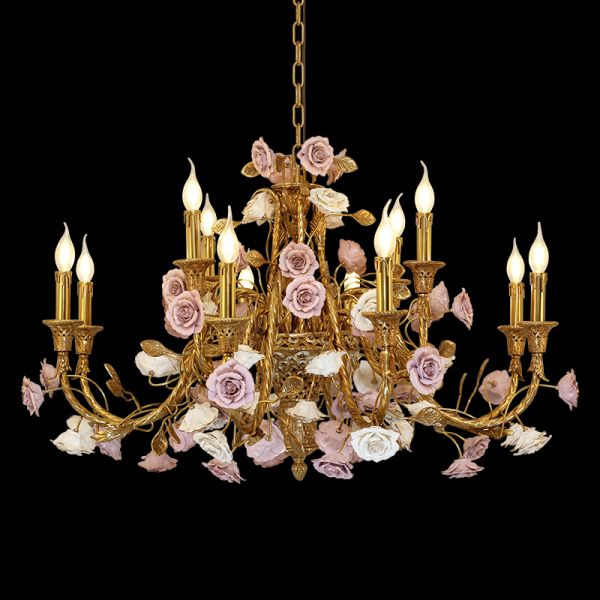 Detailed view of a French ceramic flower brass chandelier with pink blooms and candle bulbs.