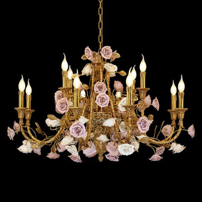 Detailed view of a French ceramic flower brass chandelier with pink blooms and candle bulbs.