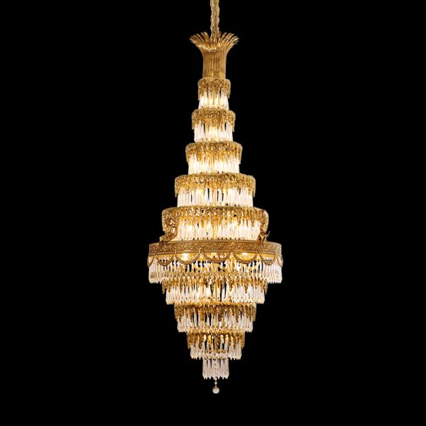 Golden Baroque brass chandelier with layered crystal fringe, isolated on black.
