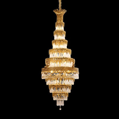 Golden Baroque brass chandelier with layered crystal fringe, isolated on black.