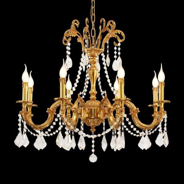 Detailed view of a golden brass chandelier with curved arms and hanging crystal prisms.