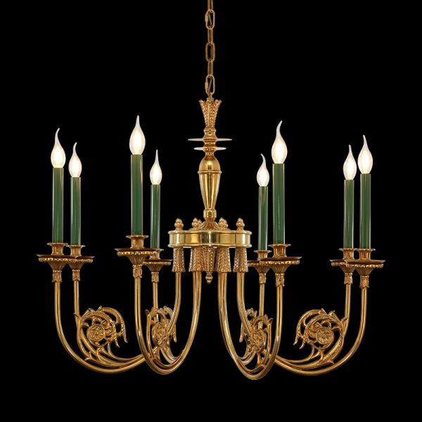 Eight-arm golden brass chandelier with detailed scrollwork and green candles, black background.