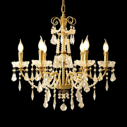 Full studio shot of the French Baroque Opulence solid brass and crystal chandelier glowing against a stark black background.
