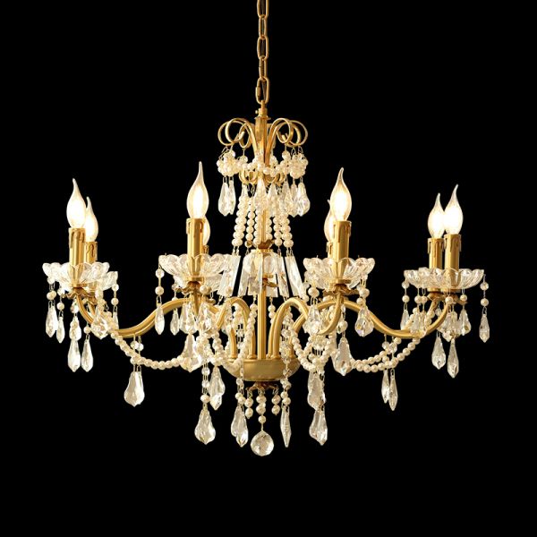 A classical chandelier installed in a grand residential lobby with ornate wall moldings and a sweeping staircase.