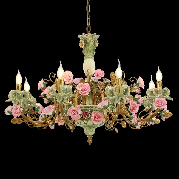 Golden brass chandelier decorated with detailed pink ceramic roses, close-up view.
