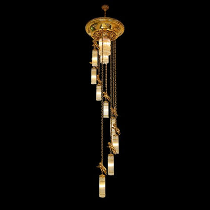 A long brass chain chandelier with cherub statues and crystal beads on black background, full view.