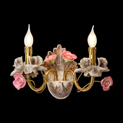 Jardin de Porcelaine brass wall sconce with ceramic roses and green vase, JEWELLERY TOP, on black background.