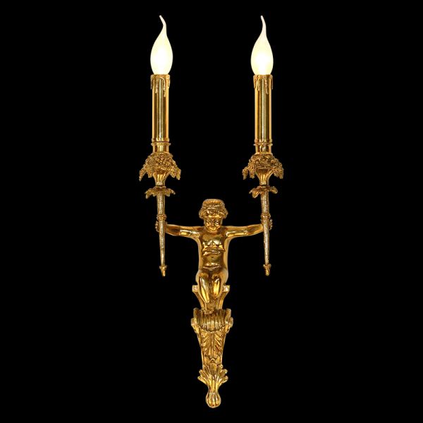 Front view of the Eros' Embrace brass wall sconce with a central cherub sculpture and two candle lights on a dark background.