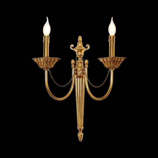 Cygne Royal dual-arm brass wall sconce with candle bulbs and bead chains on black, JEWELLERY TOP.