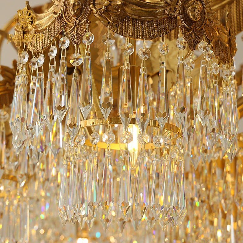 Close-up detail of K9 crystal pendants and golden brass scrollwork on a luxury chandelier.