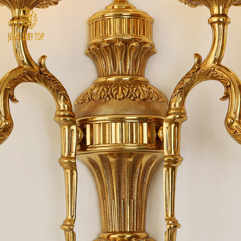 Close-up focus on the sconce's mid-section, highlighting the fluted column and detailed classical patterns.