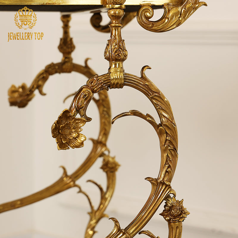 Close-up of the elaborate Rococo brass leaf scrollwork and floral leg joins on the bar cart by Jewellery Top.