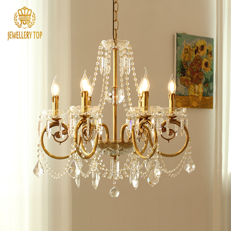JEWELLERY TOP brass chandelier in a room with white curtains and a sunflower painting.