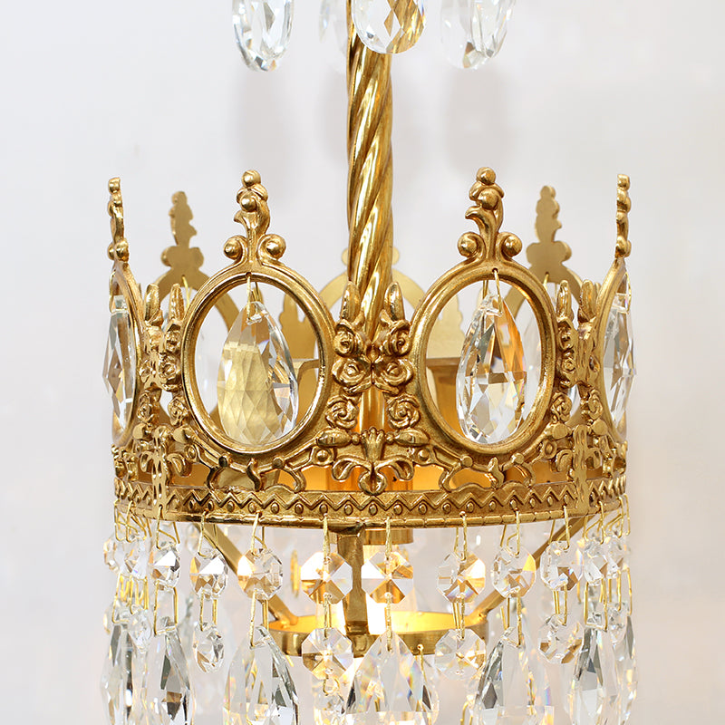 Front view of the crystal decorative wall light, showcasing its crown design and warm bulb glow.