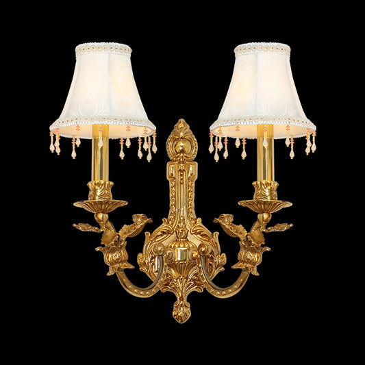 Front product view of the Hôtel de Lune golden brass wall sconce with lace-trimmed shades and crystal fringes on a black background.