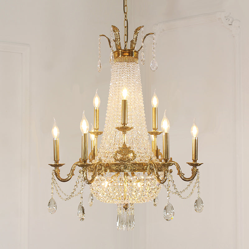 Front display of a luxurious brass chandelier with candle bulbs and sparkling prisms.